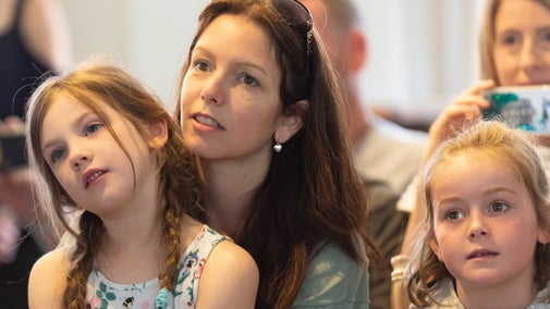 Children and adults watching a performance